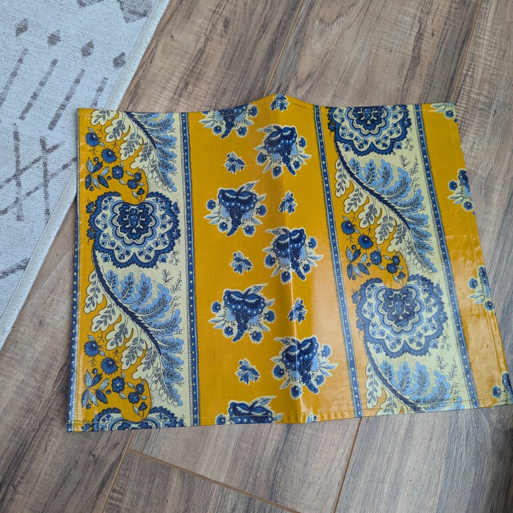 Le cluny laminated placemats golden yellow with blue florals made in france.